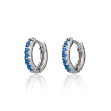 Huggie earrings with blue stones in Silver by Scream Pretty